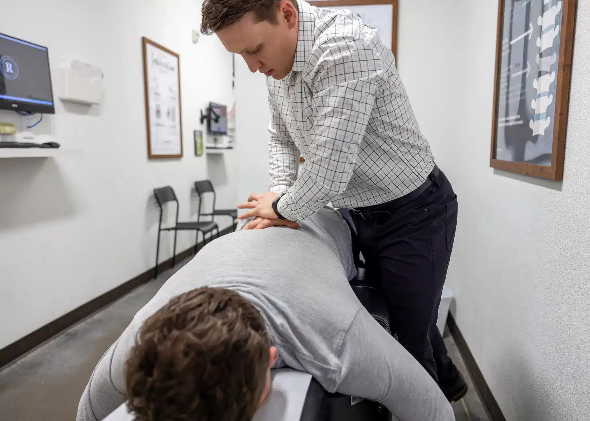 Gentle, neurologically-based lumbar adjustment for a sciatica patient at Restoration Chiropractic in Prosper, TX